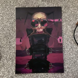 May include: An abstract painting featuring a figure with large, round, red-tinted goggles and a skeletal face. The figure is depicted in a dark, black outfit against a backdrop of deep pink and purple hues. The artwork has a surreal, unsettling aesthetic.