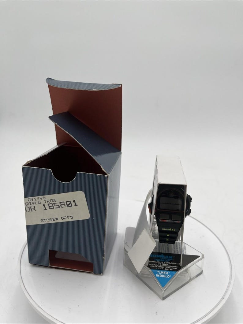 May include: A white ceramic mug with a black handle and the text "But First, Coffee" in a black, bold font. The mug is sitting on a white surface.