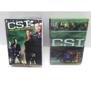 May include: Two DVD box sets of the television show "CSI: Crime Scene Investigation." The box sets feature images of the show's cast and the show's logo. The text "The Complete Fifth Season" is visible on one box set.