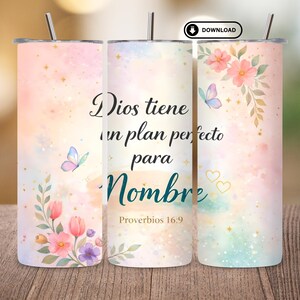May include: A set of three stainless steel insulated tumblers with lids and straws. Each tumbler features a watercolor design with pastel colors, floral accents, butterflies, and the Spanish text "Dios tiene un plan perfecto para Nombre" (God has a perfect plan for Name).