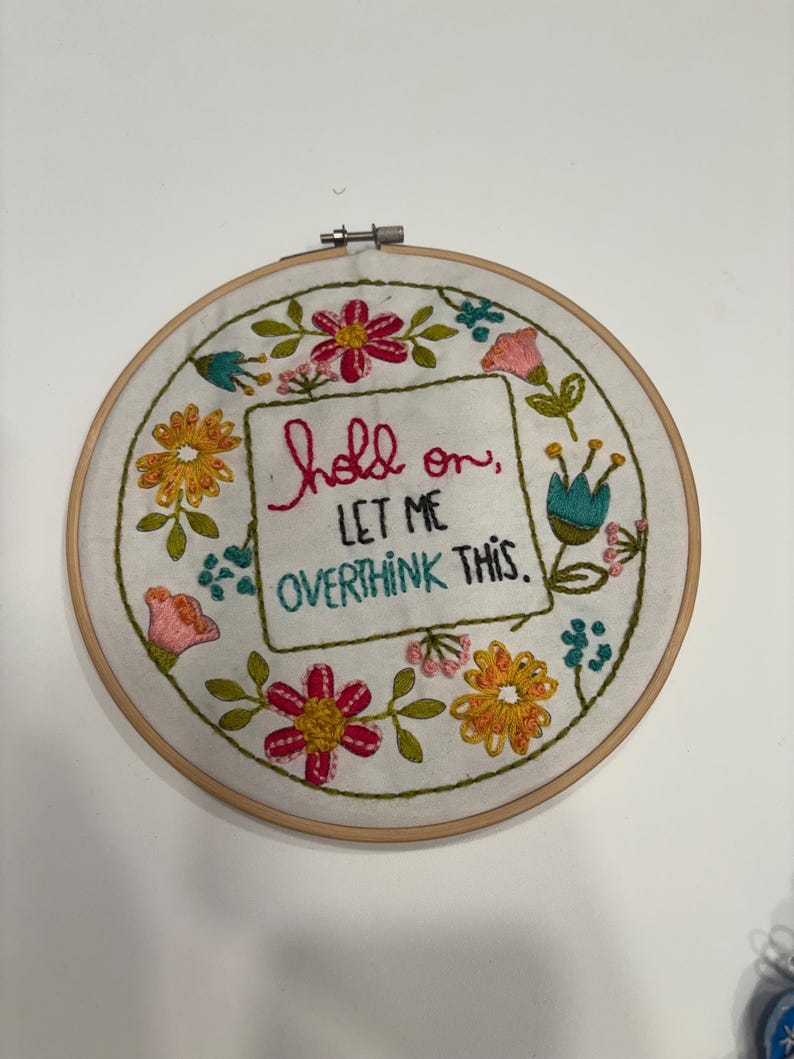 Embroidery Hoop Art Wall Hanging Funny Quote Design Hand Stitched Textile Piece Colorful Floral Pattern Overthinking Humor Text Handmade Fiber Art Quirky Office Desk Accessory Mental Health Gift Idea Anxiety Relief Item Display Shelf Decor
