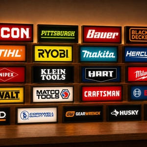May include: A collection of rectangular, illuminated signs featuring various tool brand logos including Icon, Pittsburgh, Bauer, Black+Decker, Stihl, Ryobi, Makita, Hercules, Knipex, Klein Tools, Hart, Milwaukee, DeWalt, Matco Tools, Craftsman, Bosch, Ridgid, Cornwell, Gearwrench, Husky, and Tekton.