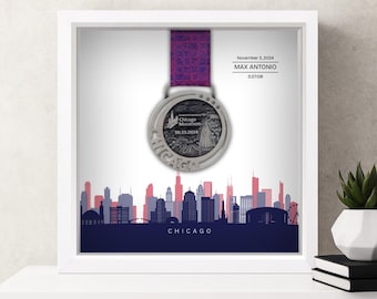 May include: Framed Chicago Marathon medal with a purple ribbon. The silver medal is displayed against a backdrop of the Chicago skyline in blue, pink, and red. The frame includes the text "Chicago" and the date "November 3, 2024".