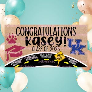May include: A banner with the words "Congratulations Kasey! Class of 2025" in black lettering. The banner includes a paw print, graduation cap, and the University of Kentucky logo. School names are listed along a road.