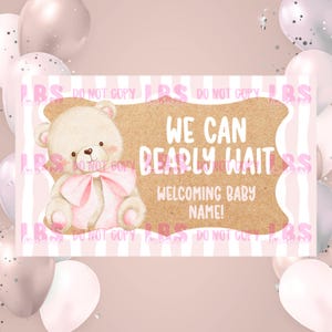 May include: A baby shower announcement card with a light brown background and a cartoon teddy bear wearing a pink bow. The text reads "We can bearly wait" and "Welcoming baby name!" on a pink and white striped background.