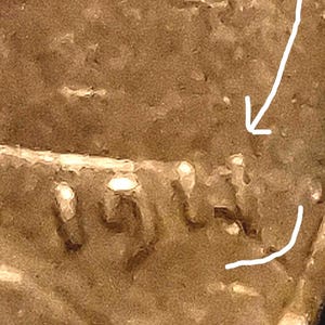 May include: A close-up view of a copper-colored coin surface featuring the embossed date 1974. A white hand-drawn arrow points toward the digit 4, and a curved white line is drawn beneath the date to highlight the specific area of the coin.