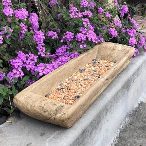 May include: A rustic wooden sign with the text "Welcome to our home" in white lettering. The sign features a distressed finish and a simple, inviting design, perfect for front door decor.