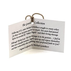 May include: A white folded paper tag with a tan string loop at the top. The text reads: The Gentilucci Collection. Following 9/11, artist Michael Gentilucci sought to create solace for those who had given and lost so much. Original Sculptures by Michael Gentilucci.