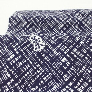 May include: A close-up of a navy blue fabric with a white geometric pattern. The fabric has a Japanese character printed on it.