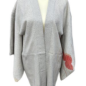 May include: A gray and white patterned kimono with a red and gold floral design on the right sleeve.