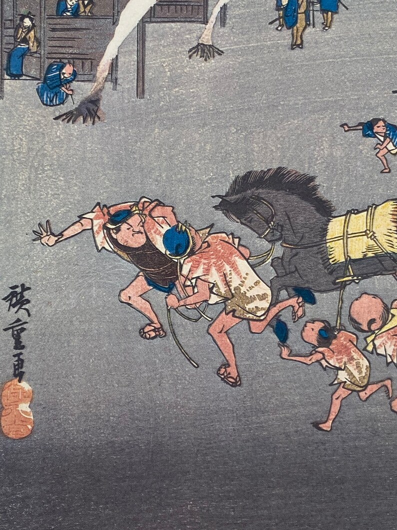 May include: Japanese woodblock print showing a busy street scene. People in traditional clothing are running alongside a horse-drawn cart. The artwork uses a muted colour palette with detailed linework, capturing a moment of action.