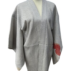 May include: A white Japanese kimono with a small black dot pattern and a red floral design on the sleeve.