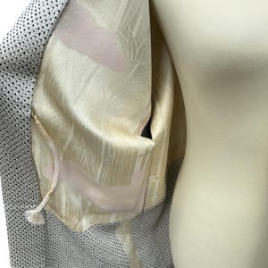 May include: A gray and white patterned kimono with a white lining featuring a pink and white bamboo design.