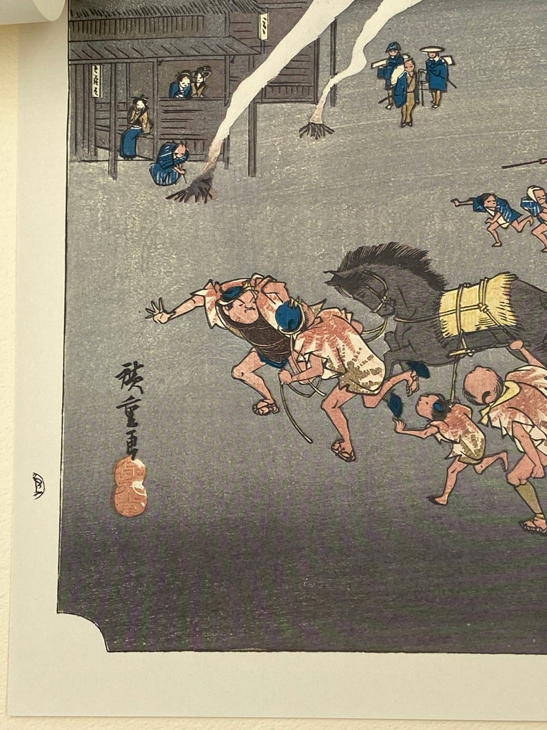May include: Japanese woodblock print showing a dynamic scene with running figures and a horse-drawn carriage. The print uses a subdued colour palette of grey, brown, and blue. The artwork displays traditional Japanese clothing and architectural details.