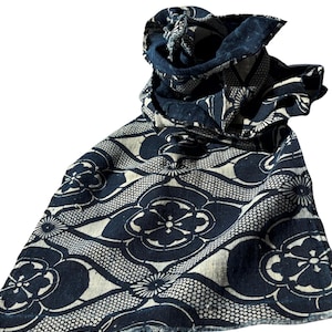 May include: A blue and white patterned scarf with a floral design. The scarf is made of a soft, lightweight fabric and is perfect for adding a touch of style to any outfit.
