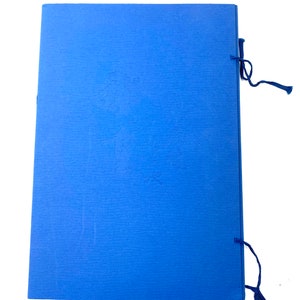 May include: A blue document folder with embossed floral designs and a textured surface. The folder is secured with a dark blue tassel tie on the right side. The folder is rectangular and has a simple design.