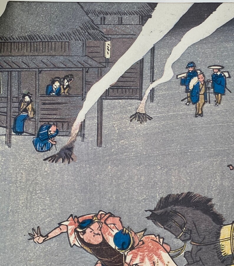 May include: Japanese woodblock print showing a street scene with figures in traditional dress. A man on horseback is in the foreground, with buildings and other figures in the background. The print uses a muted colour palette with shades of grey, blue, and brown.