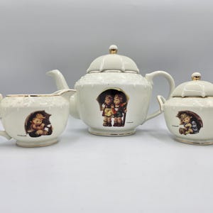 May include: A set of three ceramic mugs with a speckled, matte finish. The mugs are in shades of cream, light gray, and dark gray. Each mug has a simple, minimalist design, perfect for coffee or tea.