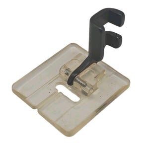 May include: A sewing machine presser foot featuring a clear, rectangular plastic base with a central needle slot and a black metal shank attachment. The component is designed for fabric guidance and pressure during the sewing process.