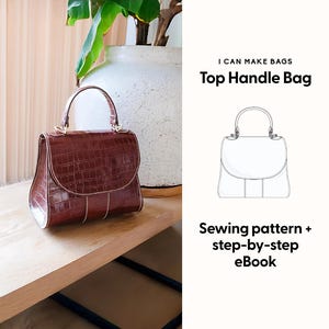 May include: A brown top handle bag with a crocodile texture sits on a wooden surface. The bag has a curved top flap and a gold-colored handle. Text on the right reads "I CAN MAKE BAGS Top Handle Bag" and "Sewing pattern + step-by-step eBook."