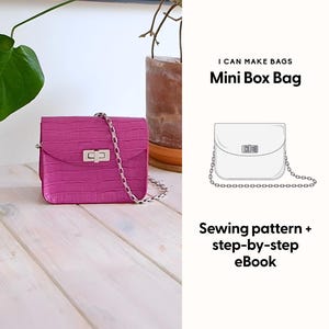 May include: A vibrant pink mini box bag with a silver chain strap and clasp. The bag features a textured, crocodile-effect pattern. The image also includes the text "I CAN MAKE BAGS Mini Box Bag" and "Sewing pattern + step-by-step eBook".