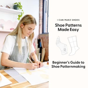 May include: A woman in a white shirt and gray apron is drawing on paper at a wooden table. A roll of tape sits in the foreground. Text on the right reads "I CAN MAKE SHOES Shoe Patterns Made Easy Beginner's Guide to Shoe Patternmaking."