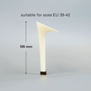 May include: A white plastic high heel shoe replacement heel, measuring 105 mm in height. Suitable for shoe sizes EU 39-42.