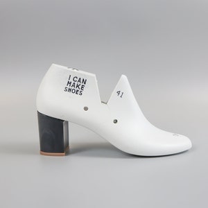 May include: White shoe last with a black heel and the text "I CAN MAKE SHOES" on the side. The last is size 41.