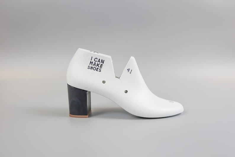 May include: White shoe last with a black heel and the text "I CAN MAKE SHOES" on the side. The last is size 41.