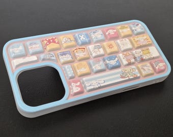 May include: A light blue phone case with a keyboard design. The case features a series of colorful, square keys with cartoon character illustrations. The keys are in shades of yellow, pink, blue, and white. The case has a rounded edge and a cutout for the phone's camera.