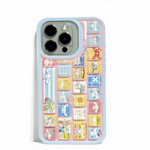 May include: A colorful phone case with a light blue border and a pink interior. The case features a grid of small, square illustrations of cartoon animals in various colors. The camera lens is visible at the top.