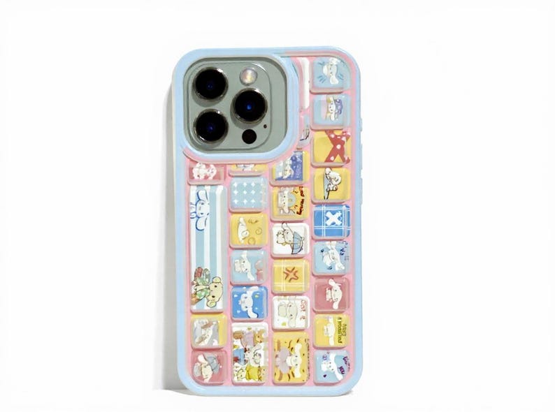 May include: A colorful phone case with a light blue border and a pink interior. The case features a grid of small, square illustrations of cartoon animals in various colors. The camera lens is visible at the top.
