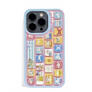 May include: A phone case with a keyboard design featuring colorful cartoon characters. The case has a light blue border and a pink background. The keyboard keys are yellow, blue, and pink, with various illustrations.
