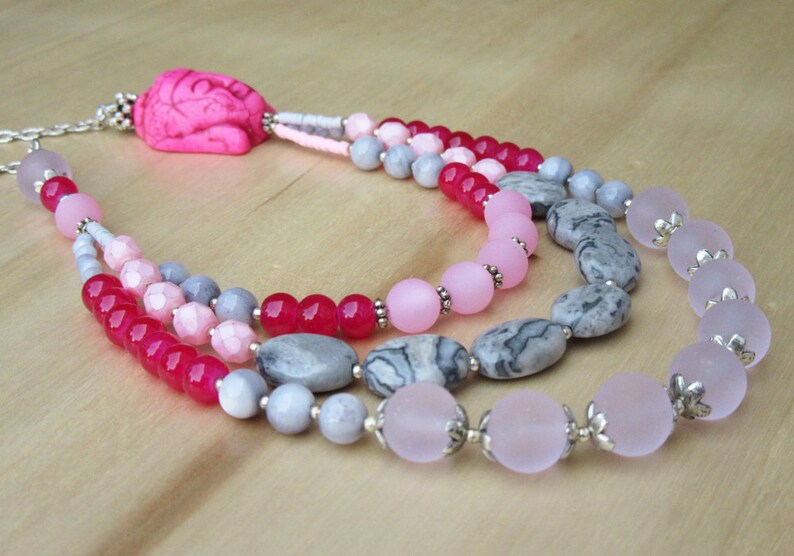 Buddha necklace in pink tones with three strands