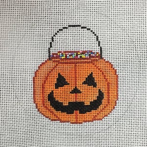 May include: Orange pumpkin-shaped trick-or-treat bag with a black smiling face and a black handle. The bag is filled with colorful candy.
