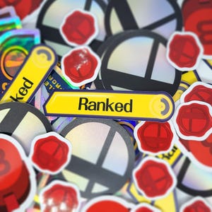 May include: A collection of stickers with a variety of designs. The stickers include a yellow arrow with the word "Ranked", black and white circular designs, and red wax seal stickers.
