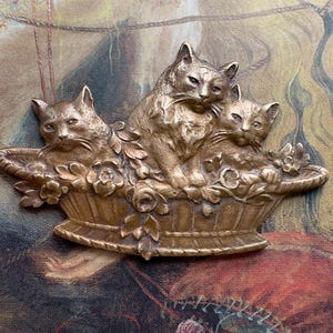 Puede incluir: Un juego de tres tazas de cerámica con un acabado mate moteado. Las tazas son de color crema, gris claro y gris oscuro. Cada taza tiene un diseño simple y minimalista.