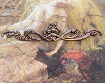 May include: A bronze-colored decorative metal piece with an ornate floral design is positioned at the bottom of a painting. The painting depicts a woman with long blonde hair, wearing a white dress, and a red hat. The text "Sara Douglass" is at the top.