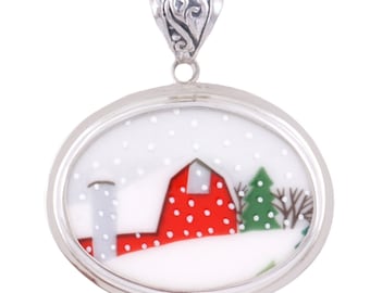 May include: A silver oval pendant with a red barn, white silo, and green tree in a snowy winter scene.
