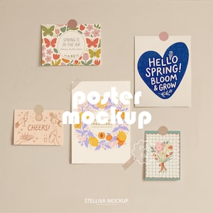 May include: A collection of five decorative posters, each with unique designs and text. One poster says "Spring is in the Air", another says "Hello Spring! Bloom & Grow". The posters are attached to a neutral wall.