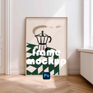 May include: A vertical rectangular wooden frame containing a print of a black moka pot on a green and white checkered surface against a cream background. The text frame mockup is overlaid in white, with a blue Ps icon and STELLIVA MOCKUP text below.