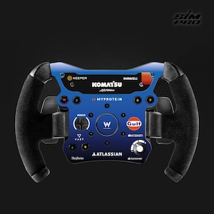 May include: A blue and black racing wheel with multiple sponsor logos, including Komatsu, Myprotein, and Gulf. The wheel has a central control panel with buttons and a textured grip on the handles. The text "SIM PRO" is in the top right corner.