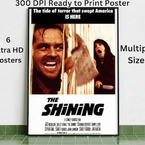 Könnte beinhalten: Ein gerahmtes Poster für den Film "The Shining" zeigt ein bedrohliches Bild von Jack Nicholson und Shelley Duvall. Das Poster enthält den Filmtitel, die Credits und den Text "The tide of terror that swept America IS HERE."