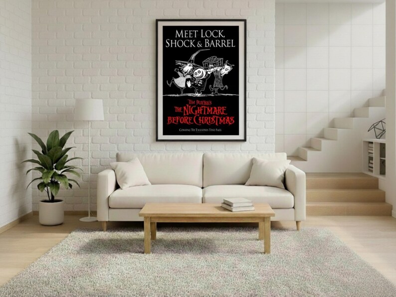 May include: A framed poster featuring the text "Meet Lock, Shock & Barrel" and "The Nightmare Before Christmas" in red and white. The poster is displayed above a white sofa, with a wooden coffee table and a potted plant in the room.