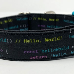 May include: Black dog collar with a colourful code pattern and the text "helloWorld() // Hello, World! helloWorld() const helloWorld = () => { return 'Hello, World!"
