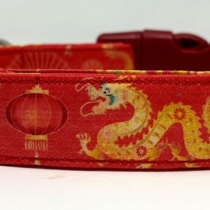May include: Red dog collar with a repeating pattern of gold dragons, red lanterns, and fans.