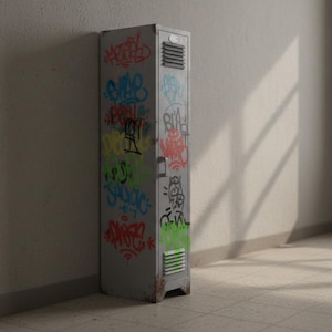 May include: A weathered, gray metal locker covered in colorful graffiti art. The locker is positioned against a light-colored wall, with sunlight casting shadows across the scene. The graffiti includes various tags and designs in multiple colors.