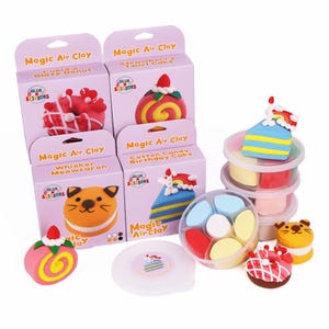May include: A collection of Magic Air Clay sets featuring colorful clay creations. The sets include boxes with images of a donut, swirl cake, cat-shaped meowcaron, and a birthday cake. Additional clay and finished models are also visible.