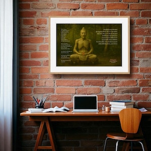 May include: A framed print featuring a seated Buddha figure with a skeletal appearance, set against a forest backdrop. The artwork includes text in English and another language, and is displayed on a brick wall above a wooden desk.
