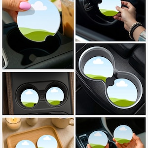 May include: Round car coasters with a landscape design featuring a blue sky, white clouds, and green hills. The coasters are shown in various car cup holders and on a wooden tray. These coasters are designed to absorb moisture.
